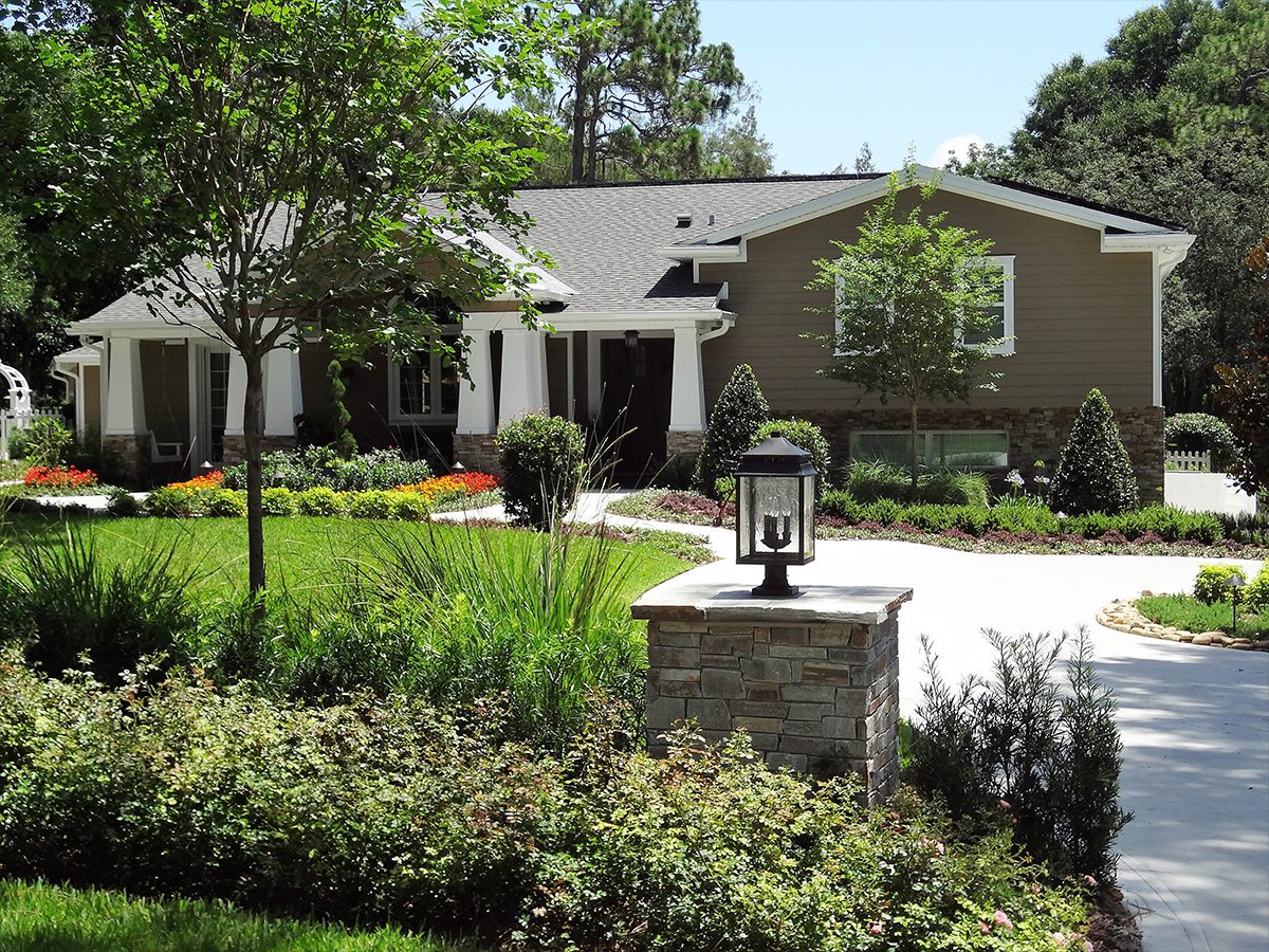 Estate landscape enhancement featuring mature landscaping, specimen trees, front entry improvements, and cohesive residential landscape design in Orlando, Florida